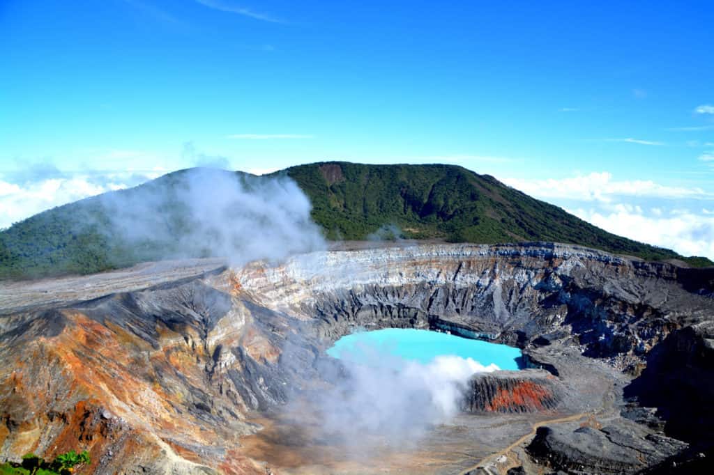 The crater of a volcano in Costa Rica with a blue lake in the middle.