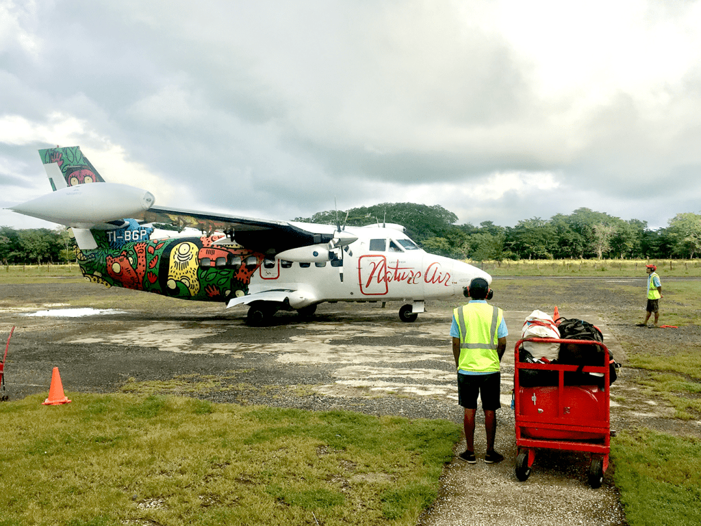 A small airplane parked on the tarmac in Costa Rica.