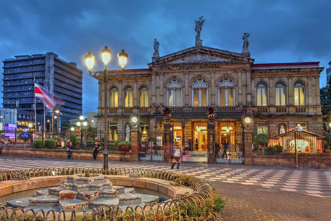 An old building with a fountain in the middle of a Costa Rican city.